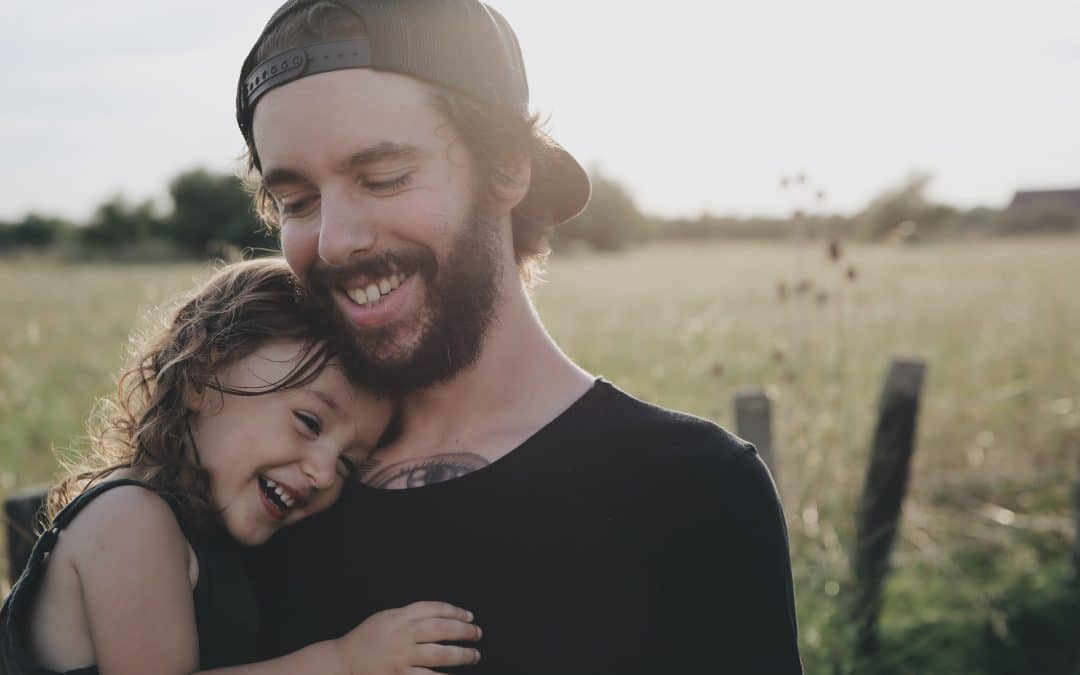 Man holding child standing in the countryside