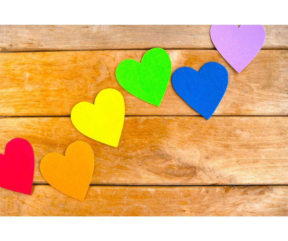 coloured hearts on wooden background