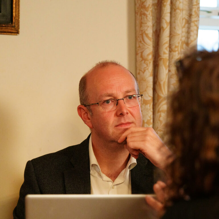 solicitor in conversation in a meeting.