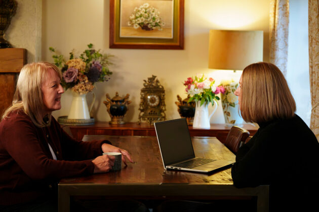 Two solicitors sat at opposite sides of a table deep in conversation.